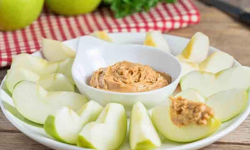 Slices of green apples with peanut butter