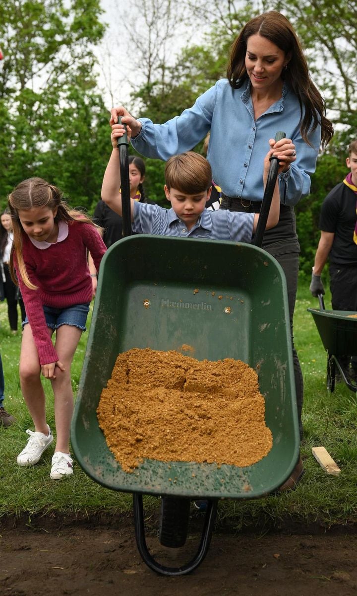 The young Prince got to work, giving his mom a helping hand with a wheelbarrow. The Princess of Wales has been joint president of the Scouts since 2020.