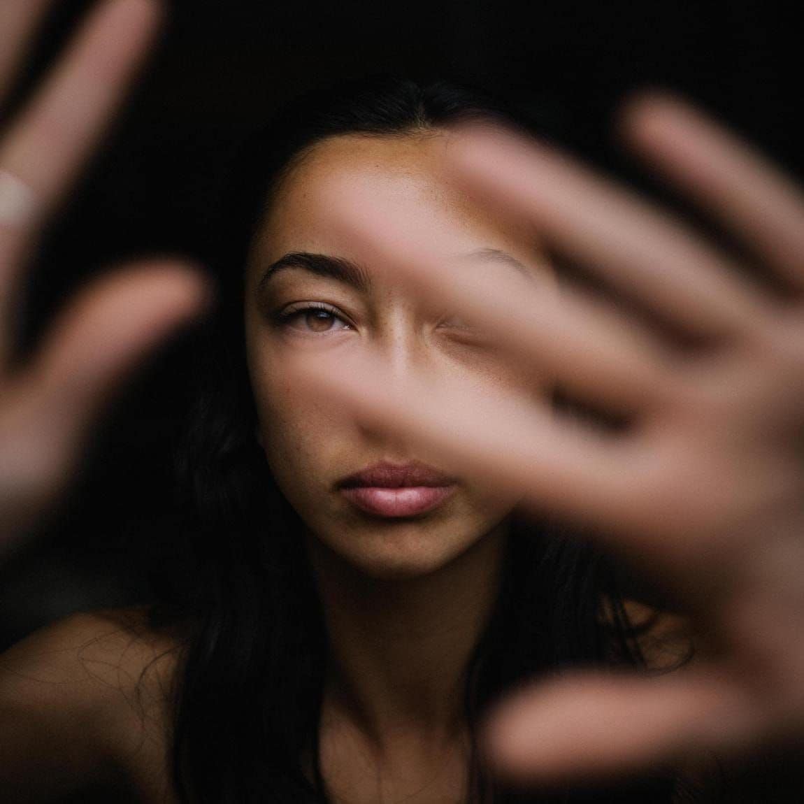 Person showing hands with bare face.