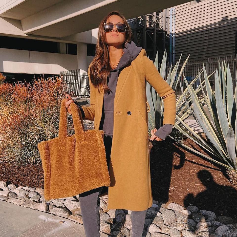 Danielle Bernstein with a camel-colored fur bag