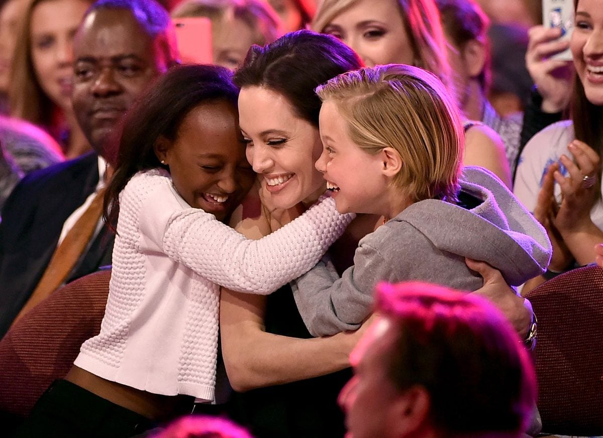 Angelina Jolie and her daughters after winning a Teen Choice Award for her work in 'Maleficient'