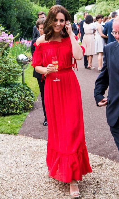 For a royal tour of Germany, the Duchess stepped out in a red Alexander McQueen dress for a garden party honoring Queen Elizabeth on July 19, 2017. The off-the-shoulder maxi dress features a cotton and silk-blend crinkled-chiffon frock from the designer's Spring 2017 collection.
Photo: Getty Images