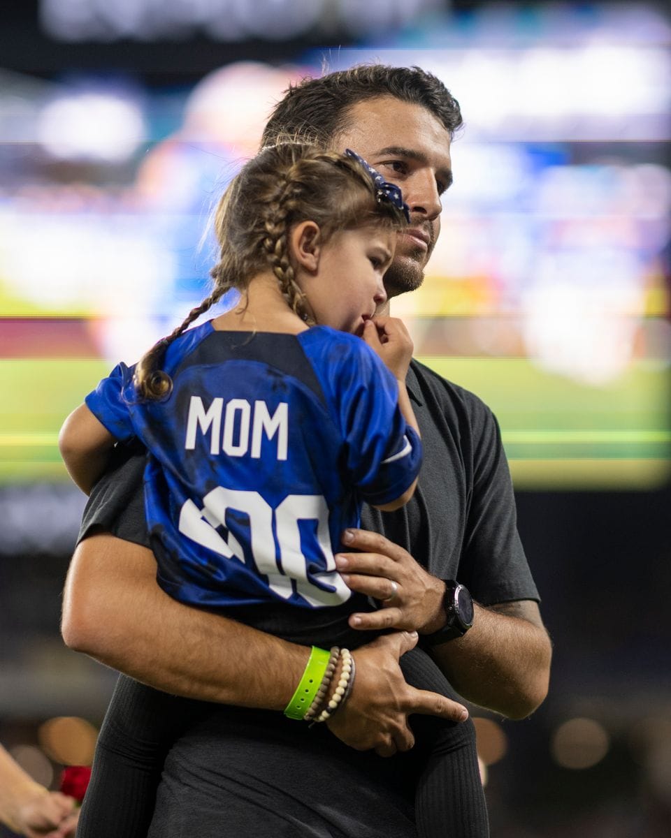 Servando Carrasco holds his daughter Charlie Elena Carrasco after attending his wife, Alex Morgan's 200th CAP ceremony before a  SheBelieves Cup game between Canada and USWNT at Exploria Stadium on February 16, 2023, in Orlando, Florida. (Photo by Roy K. Miller/ISI Photos/Getty Images)