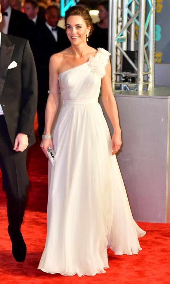 Kate Middleton in a white gown with an asymmetric neckline