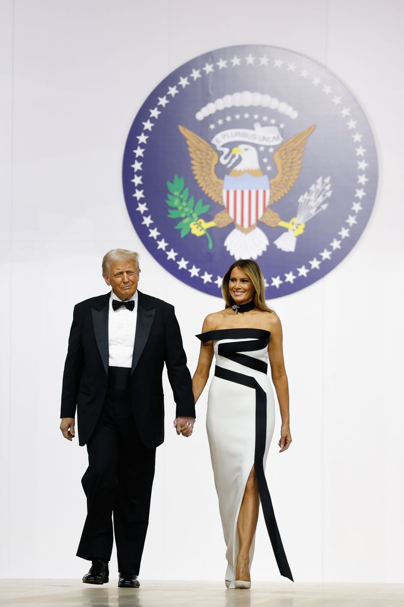 President Donald Trump walks onstage with wife Melania at the Commander-in-Chief Ball 