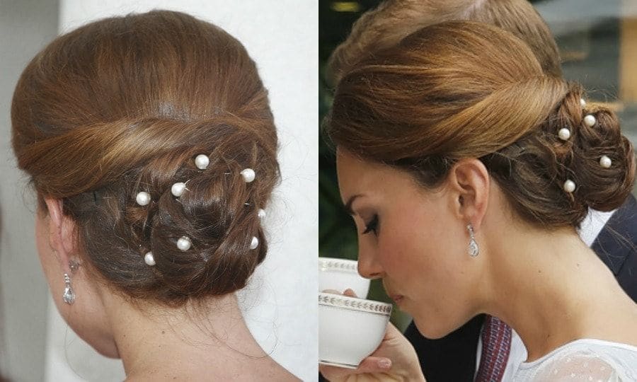 As Jackie Kennedy once said, "Pearls are always appropriate." The Duchess added flair to her chic bun with pearl bobby pins for a 2012 tea party at the British High Commission Residence in Malaysia.
Photo: PA/Danny Lawson - Pool/Getty Images