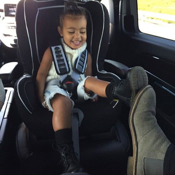 <b>April 2015</b>
<br>
It seems North knew last April that turtlenecks would be the next big thing in fashion! In a rare smiling snap, North happily plays footsie with her dad.
</br><br>
Photo: Instagram/@kimkardashian