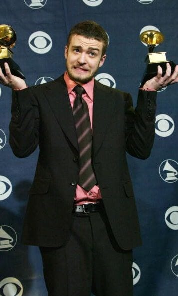 Suited up, with a reason to celebrate during the Grammy Awards in February 2004.
<br>
Photo: Getty Images