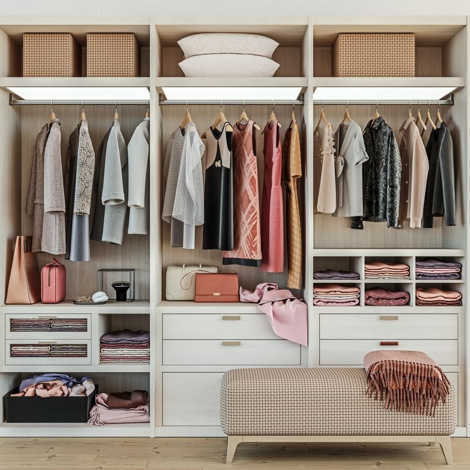 Modern wooden closet with women's clothes