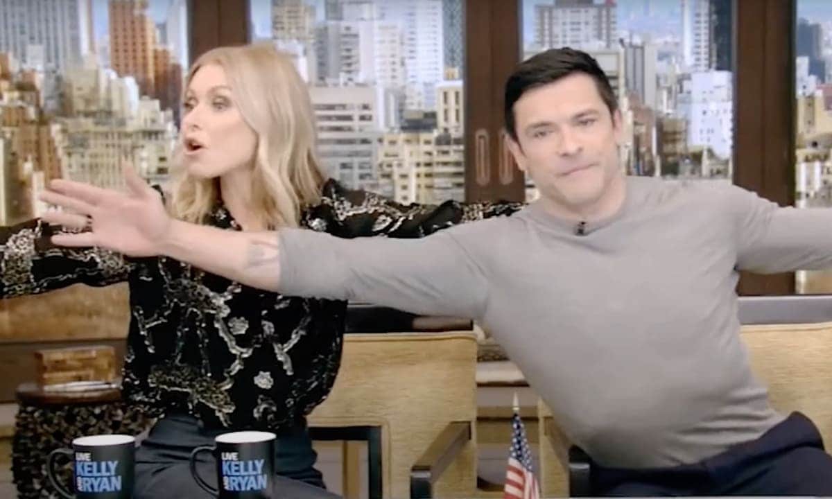 Kelly Ripa and Mark Consuelos explain how they can hold hands despite their arm’s length