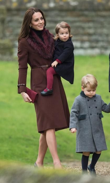 Kate Middleton with burgundy coat alongside Prince George and Princess Charlotte