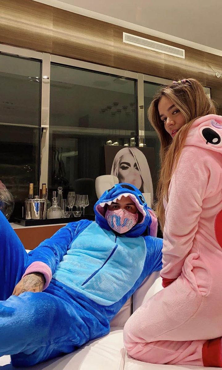 Anuel AA and Karol G wearing Disney onesies