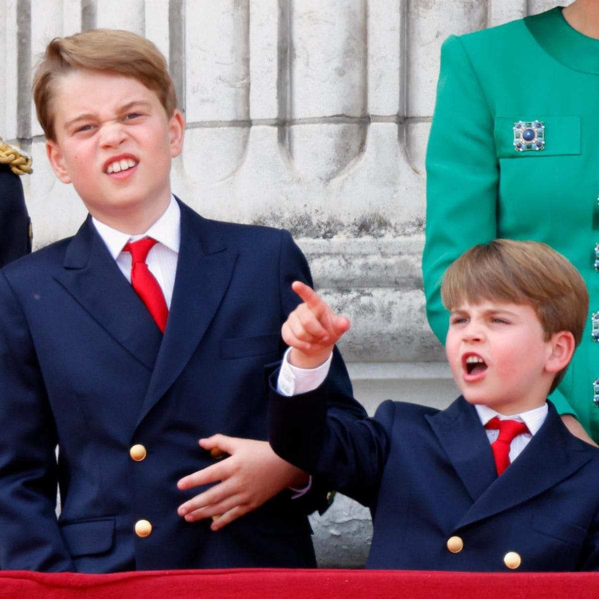 The royal brothers twinned wearing navy jackets and red ties.