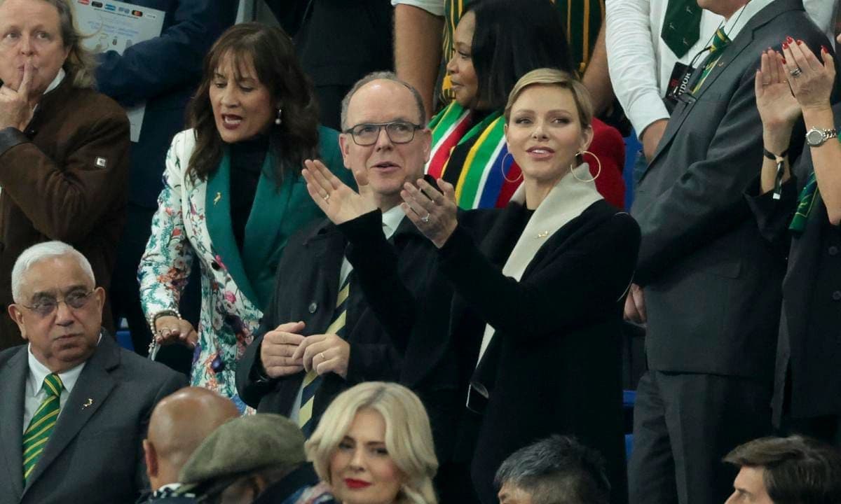 Princess Charlene completed her chic sporting event look with hoop earrings.