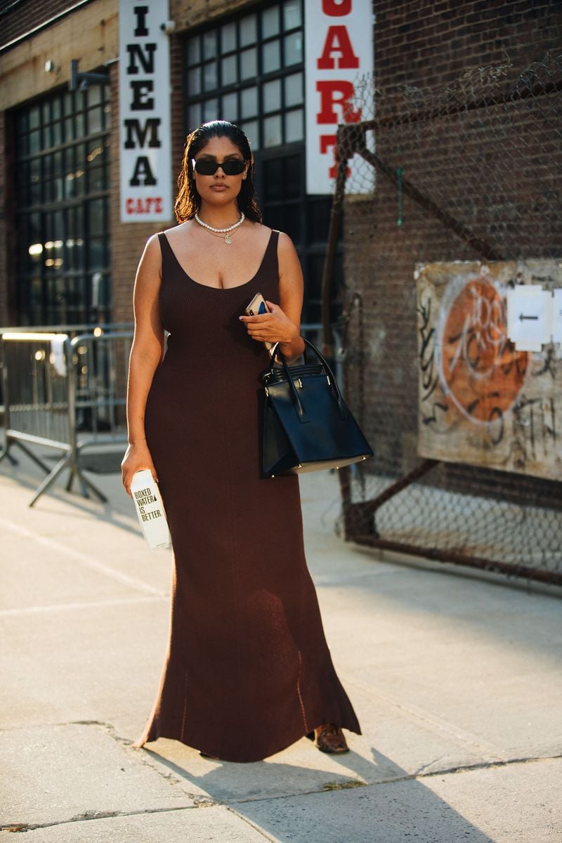  Model Jocelyn Corona wears black sunglasses, a brown body con dress