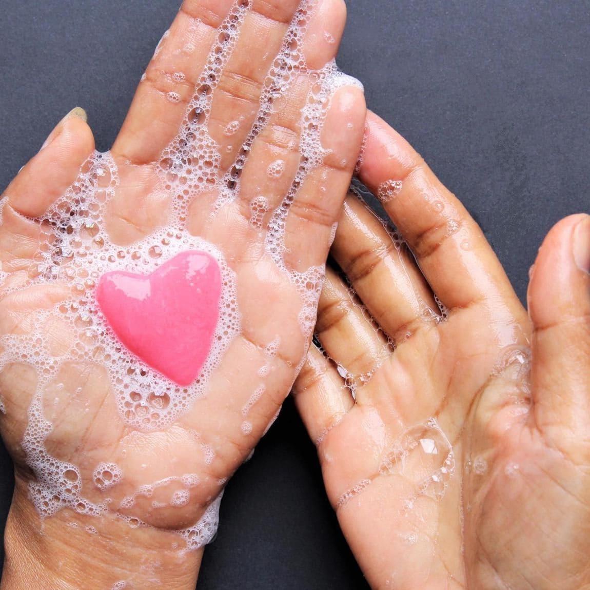 Woman washing her hands with soap