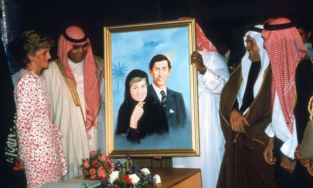 A picture of the Waleses is presented to Prince Charles and Princess Diana on a tour of Saudi Arabia