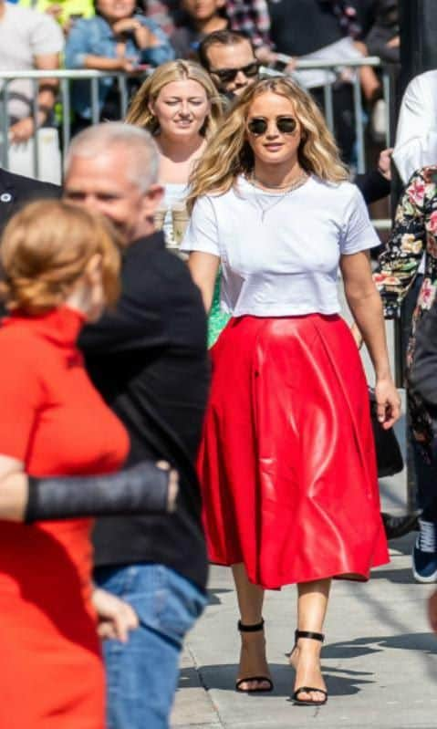 Jennifer Lawrence's white crop top and red leather midi skirt outfit