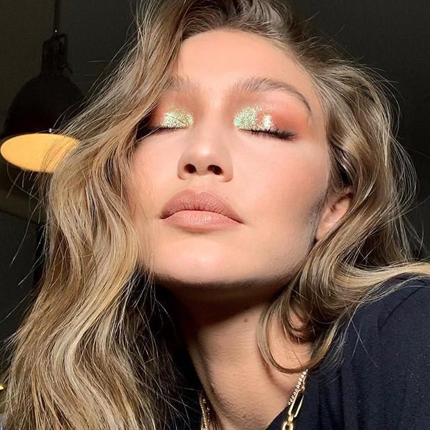 Gigi Hadid wearing green and orange eye shadow