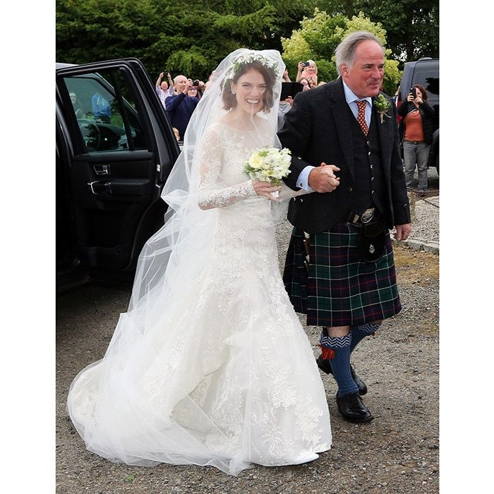 The bride made her entrance on her father Sebastian's arm wearing a long-sleeved ivory gown by Elie Saab with lace embroidery and a sheer illusion bodice.
Photo: Getty Images