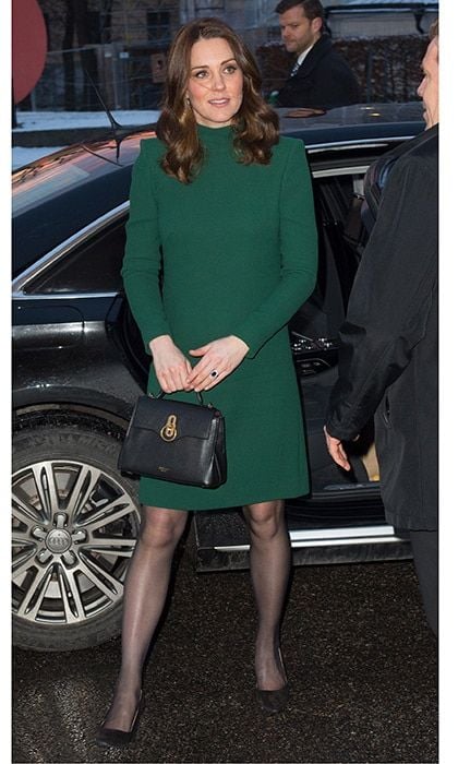 During the same visit, she showed off what she had on underneath the winter coat: a matching green Catherine Walker dress.
Photo: WENN