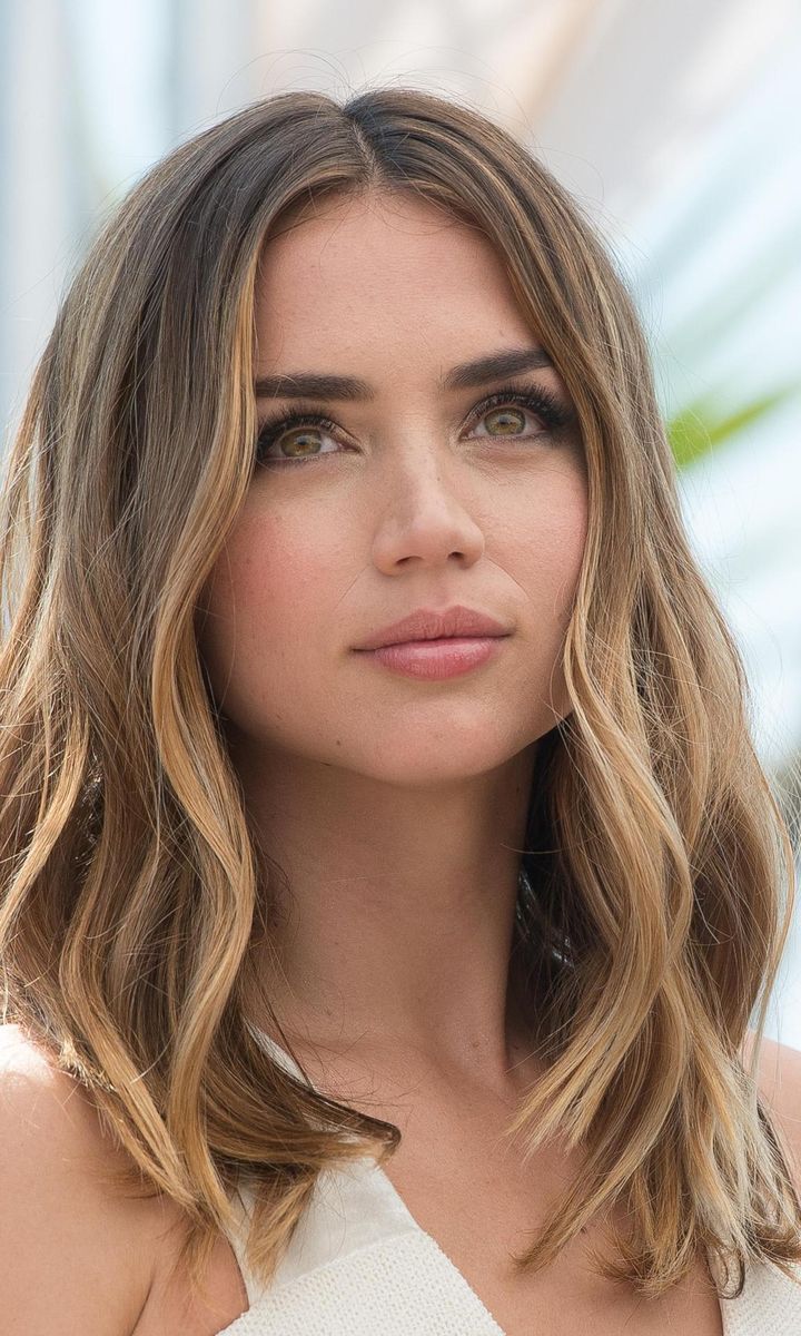 Ana de Armas with blond hair and soft curls