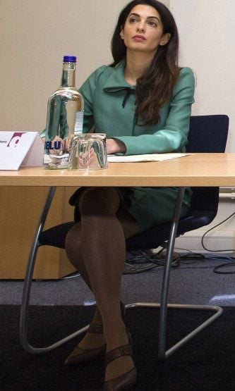 Even though she is sitting down, her style still shows. Amal worked the board room in green, paired with brown shoes during a press conference in London.
<br>
Photo: Getty Images