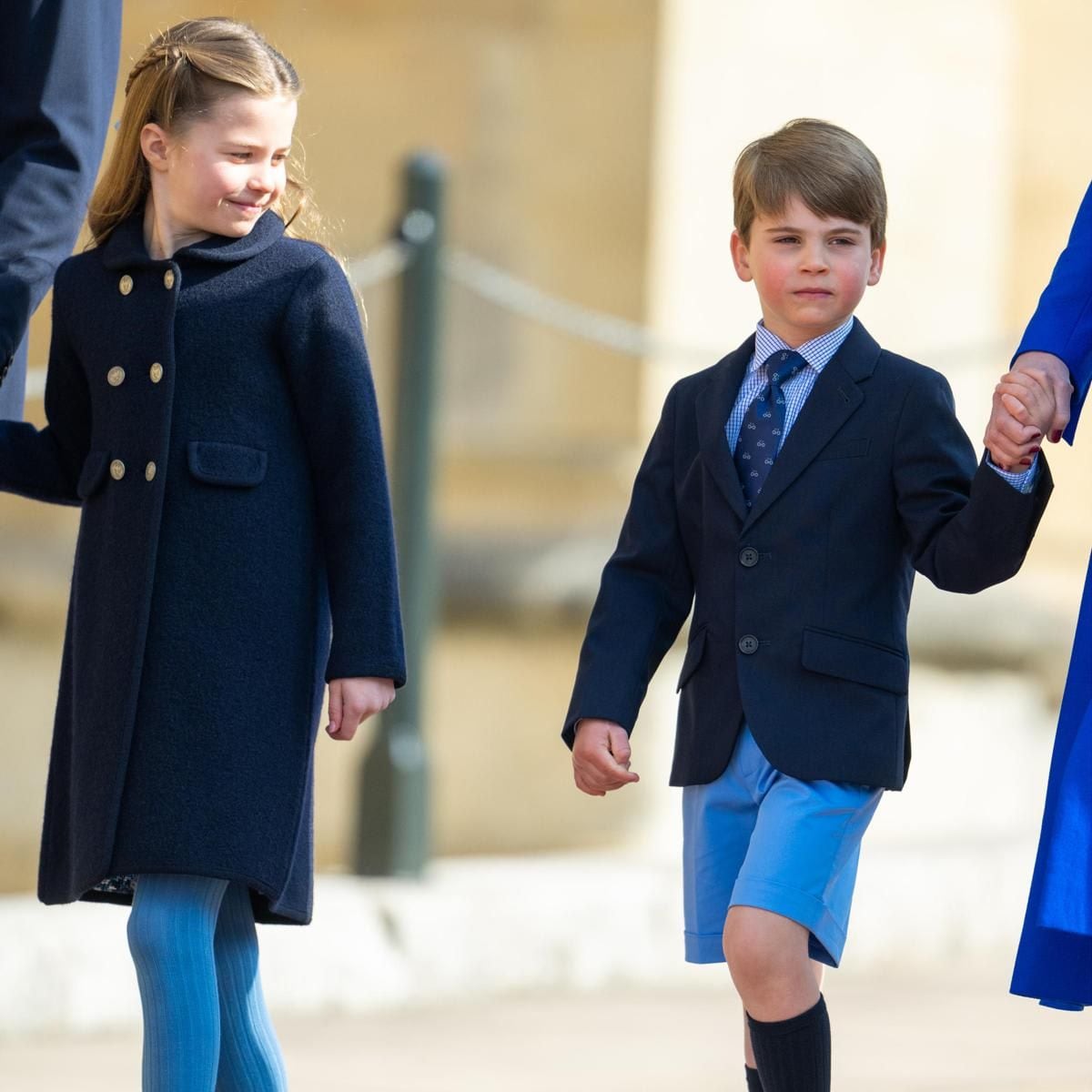 Doting big sister Charlotte looked on at her little brother as they walked to the service.