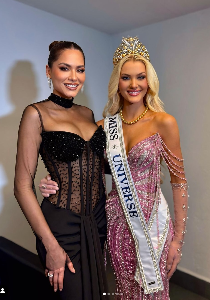 Miss Universe 2024 Victoria Kjær Theilvig posing next to Miss Universe 2020 Andrea Meza who is wearing a design from Bride to Be by Suzelle Taveras