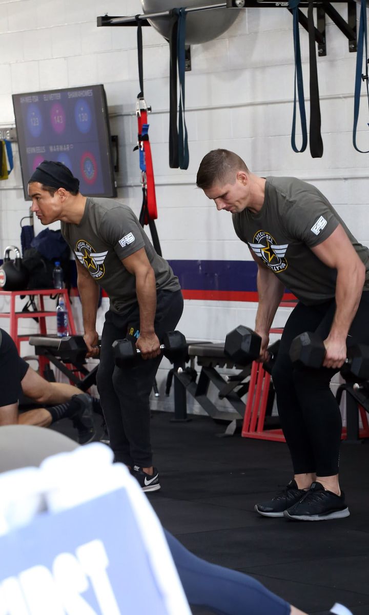 Mark Wahlberg leads a fitness class and coaches Mario Lopez