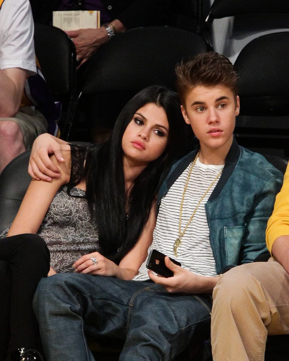   Selena Gomez (L) and Justin Bieber attend a basketball game between the San Antonio Spurs and the Los Angeles Lakers at Staples Center on April 17, 2012 in Los Angeles, California.  (Photo by Noel Vasquez/Getty Images)