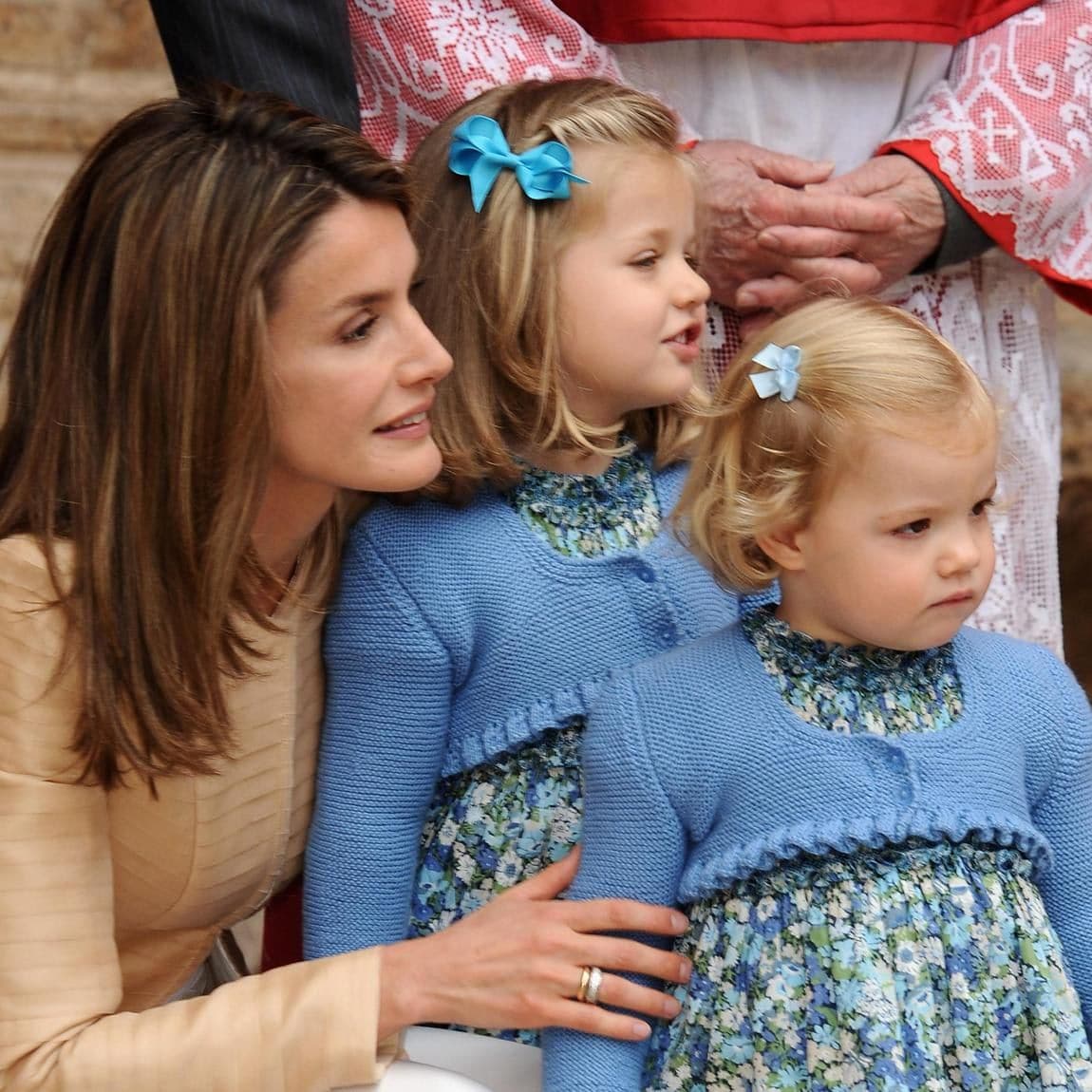 The mom of two crouched down to her daughters' level as they left Easter mass in 2009.