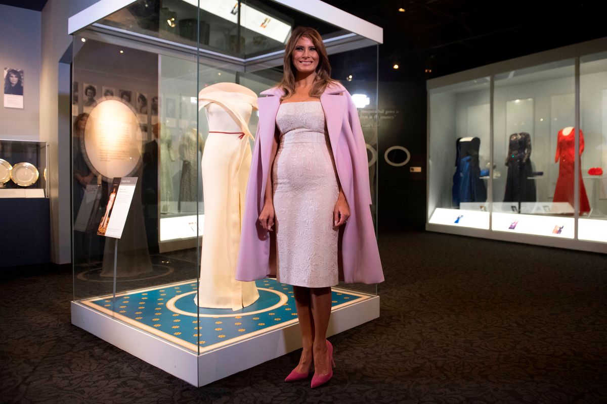 Melania Trump stands alongside the gown she wore to the 2017 inaugural balls as she donates the dress to the Smithsonian's First Ladies Collection at the Smithsonian National Museum of American History in Washington, DC, October 20, 2017. (Photo by SAUL LOEB / AFP) (Photo by SAUL LOEB/AFP via Getty Images)