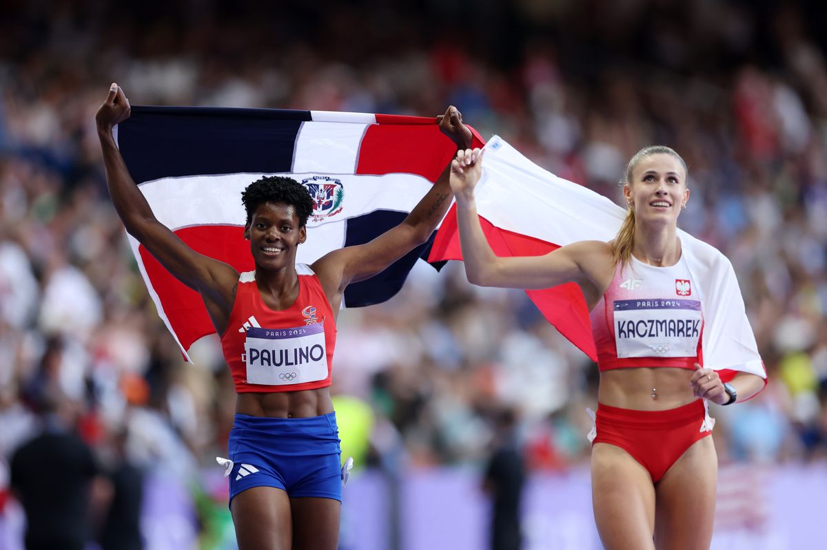 Marileidy Paulino of Team Dominican Republic celebrates winning the Gold medal with bronze medalist Natalia Kaczmarek of Team Poland in the Women's 400m Final on day fourteen of the Olympic Games Paris 2024 at Stade de France on August 09, 2024 in Paris, France. (Photo by Christian Petersen/Getty Images)