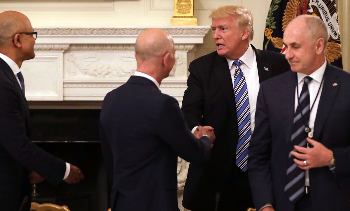 U.S. President Donald Trump (3rd L) greets Amazon CEO Jeff Bezos (2nd L), Microsoft CEO Stya Nadella (L) and White House Director of Strategic Initiatives Chris Liddell before a meeting of the American Technology Council in the State Dining Room of the White House June 19, 2017 in Washington, DC. According to the White House, the council's goal is "to explore how to transform and modernize government information technology."  (Photo by Chip Somodevilla/Getty Images)