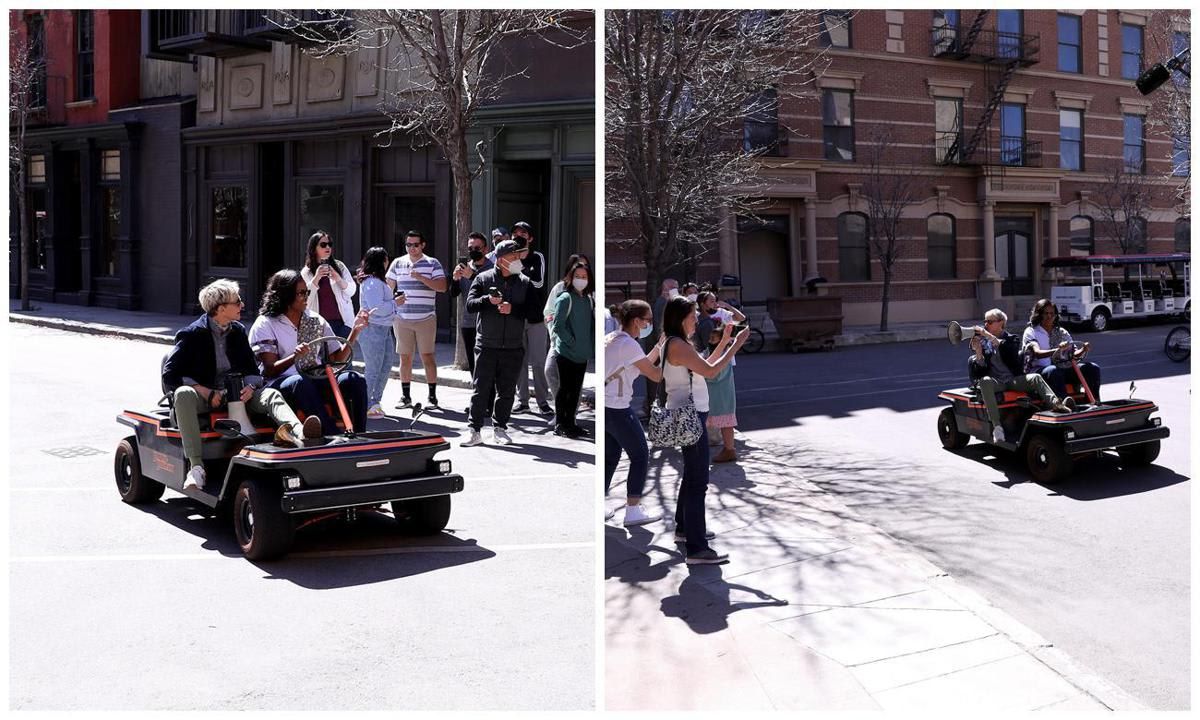 Michelle Obama and Ellen DeGeneres driving around the Warner Bros. lot in a golf cart