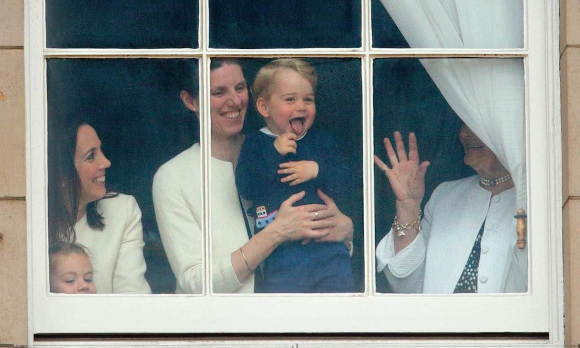 Prince George was seen laughing as his nanny Maria Teresa Turrion Borrallo held him up to watch the festivities from a window at Buckingham Palace in 2015.