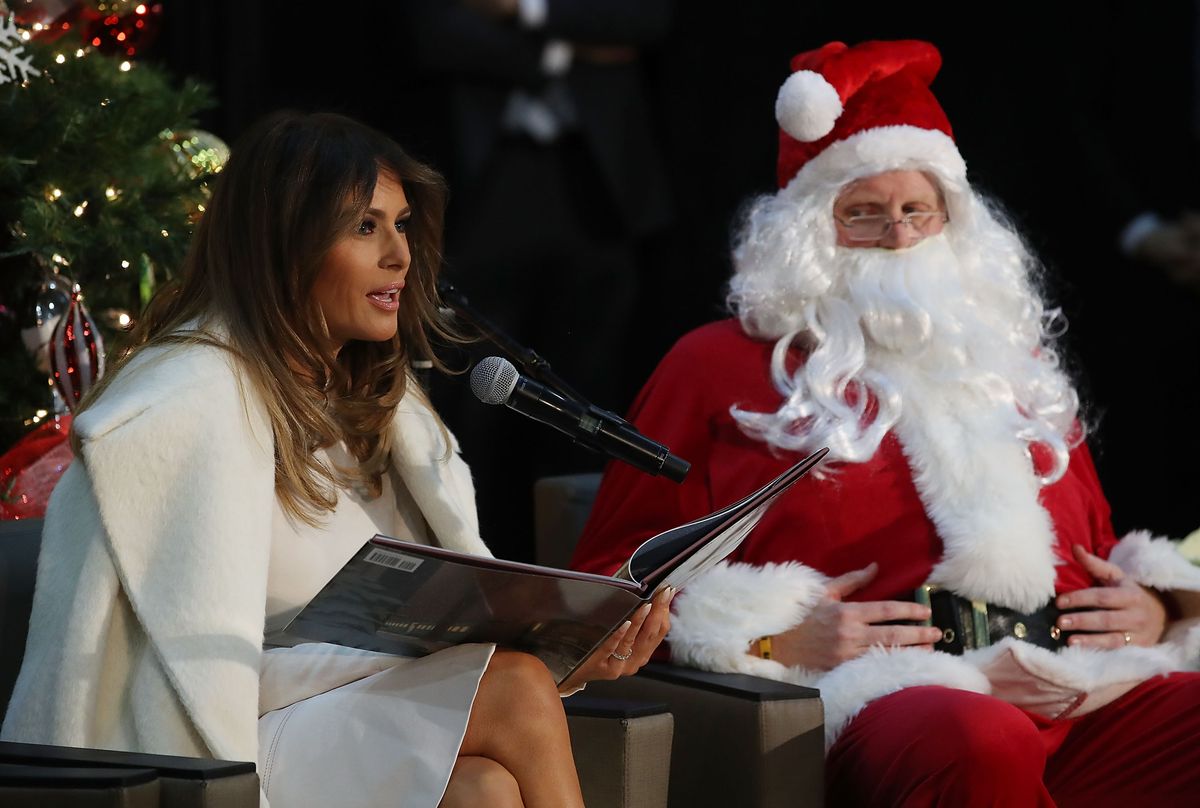 Melania Trump sits next Santa Claus as she reads the Christmas book, The Polar Express to children at Children's National Medical Center