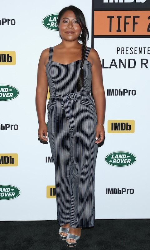 Yalitza Aparicio in vertical striped jumpsuit