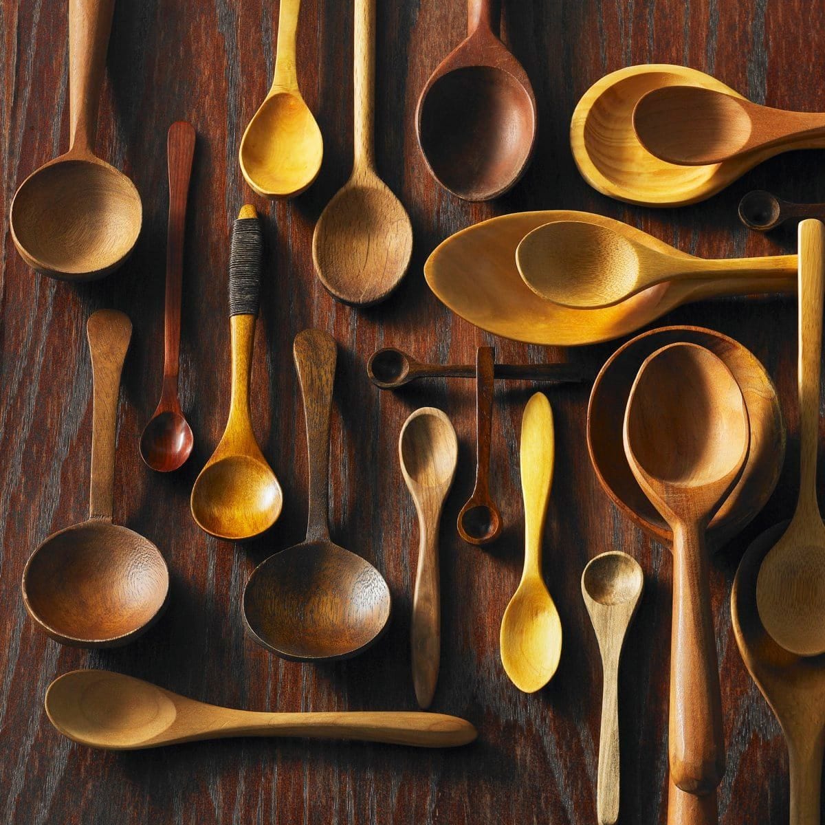 Assorted wooden spoons on a wooden surface