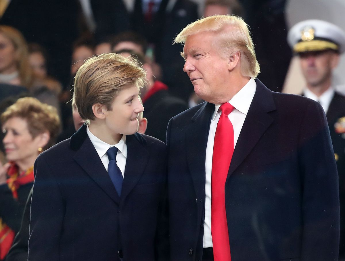 Donald Trump stands with his son Barron Trump inside of the inaugural parade in 2017