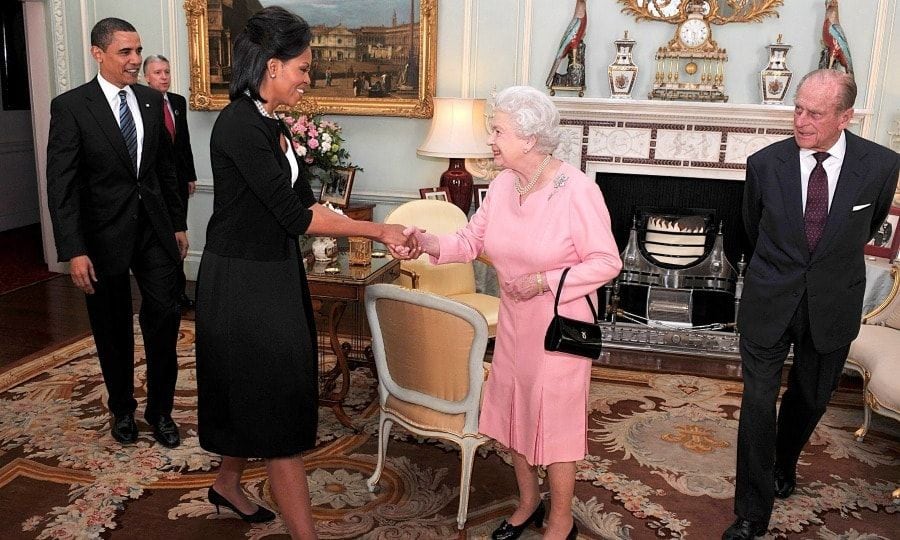 <b>6. She had a classic mom moment with the Queen</b>
Royal watchers were stunned at the images of Michelle breaking protocol by putting her arm around Queen Elizabeth upon her initial meeting with the British monarch in 2009. Always cool, the Queen embraced Mrs. Obama's gesture, making a mom moment that was one for the books.
Photo: Getty Images