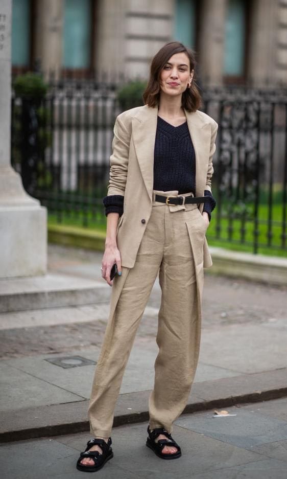 Alexa Chung wearing dad sandals in black with a beige suit