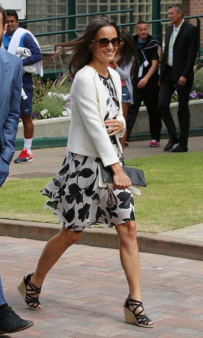 Pippa topped this floaty black-and-white print dress with a white knit jacket.
<br>
Photo: Getty Images