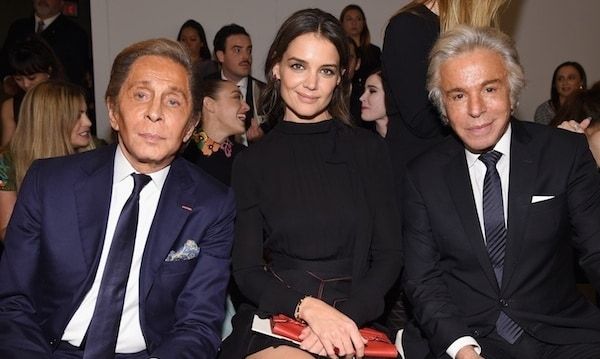 Katie sits between Valentino Garavani and business partner Giancarlo Giammetti at a star-studded party in New York City on Dec. 10.