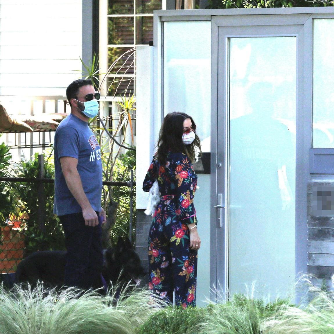 Ben Affleck and Ana de Armas arrive home after walking their dogs only to be locked out and Ben has to jump the fence to get in.