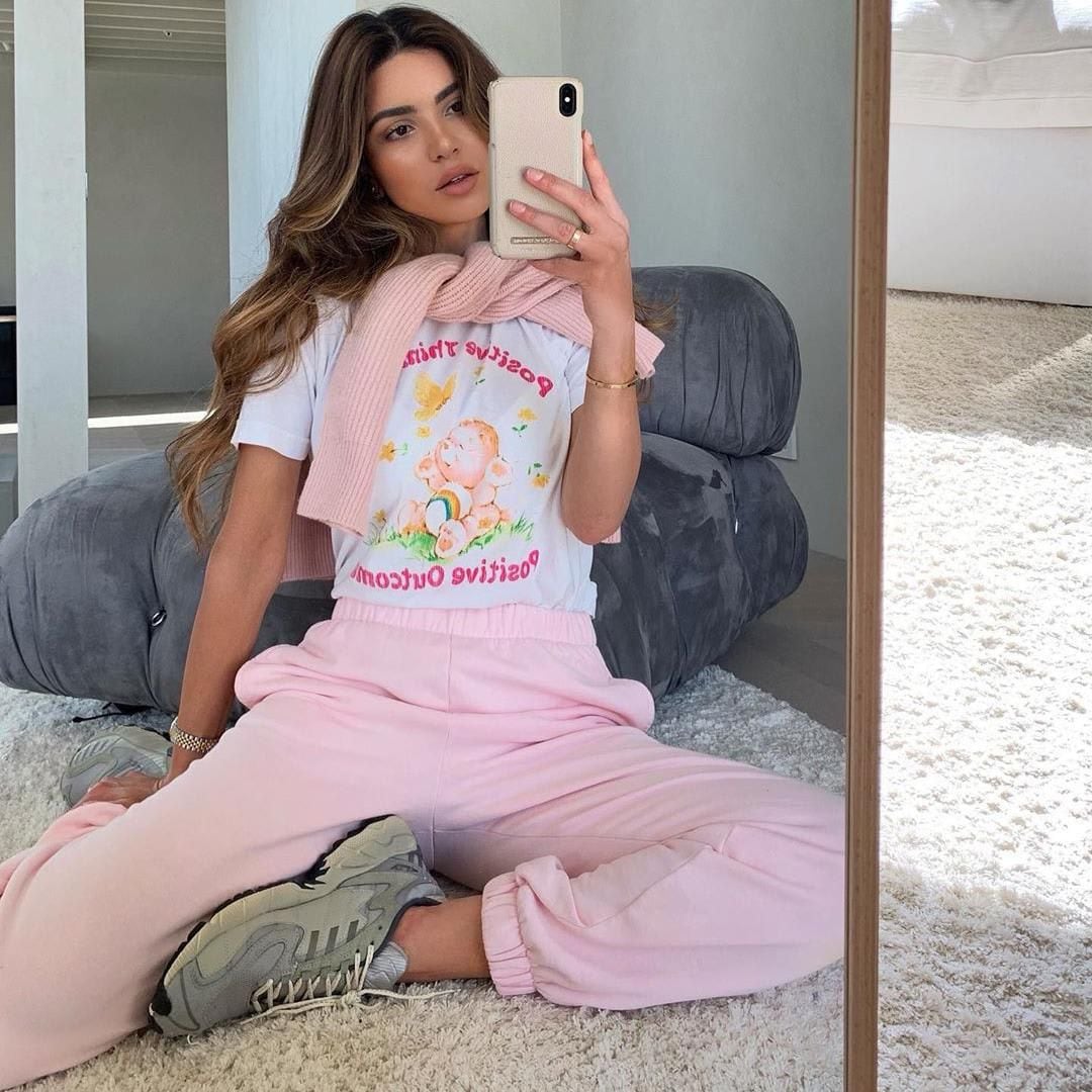 Negin Mirsalehi with combination of printed cotton T-shirt and pink sweater and sweatpants.