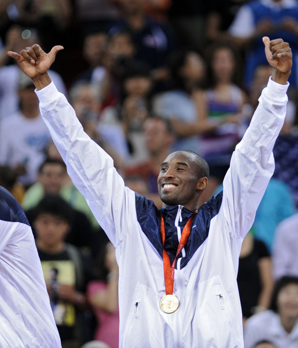 Kobe Bryant celebrates on the podium after the men's basketball gold medal match of the Beijing 2008 Olympic Game