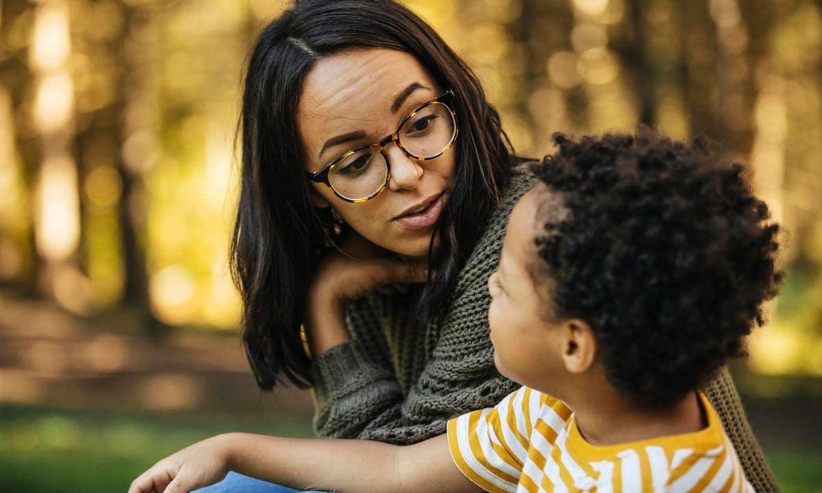 Mother talking to son outdoors