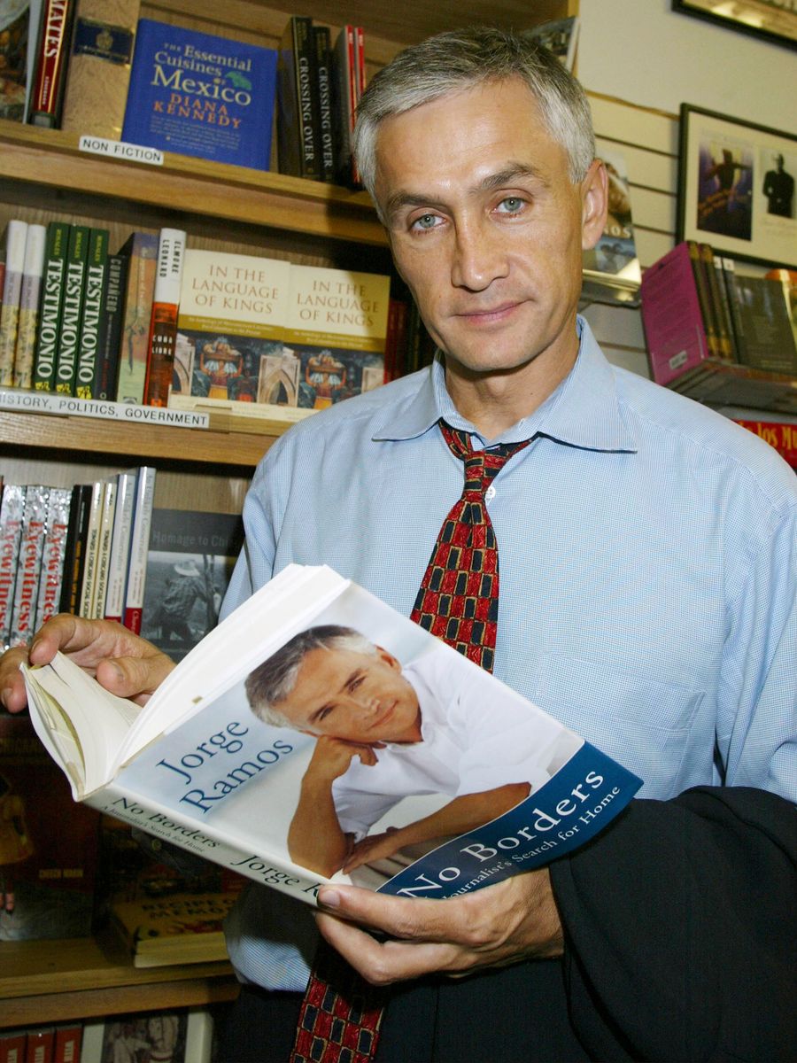 Jorge Ramos poses with his book "No Borders" at a book signing October in Long Beach, California.  